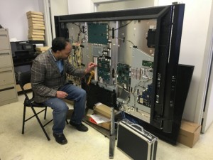 Oakville TV Repair technician repairing TV at Shop